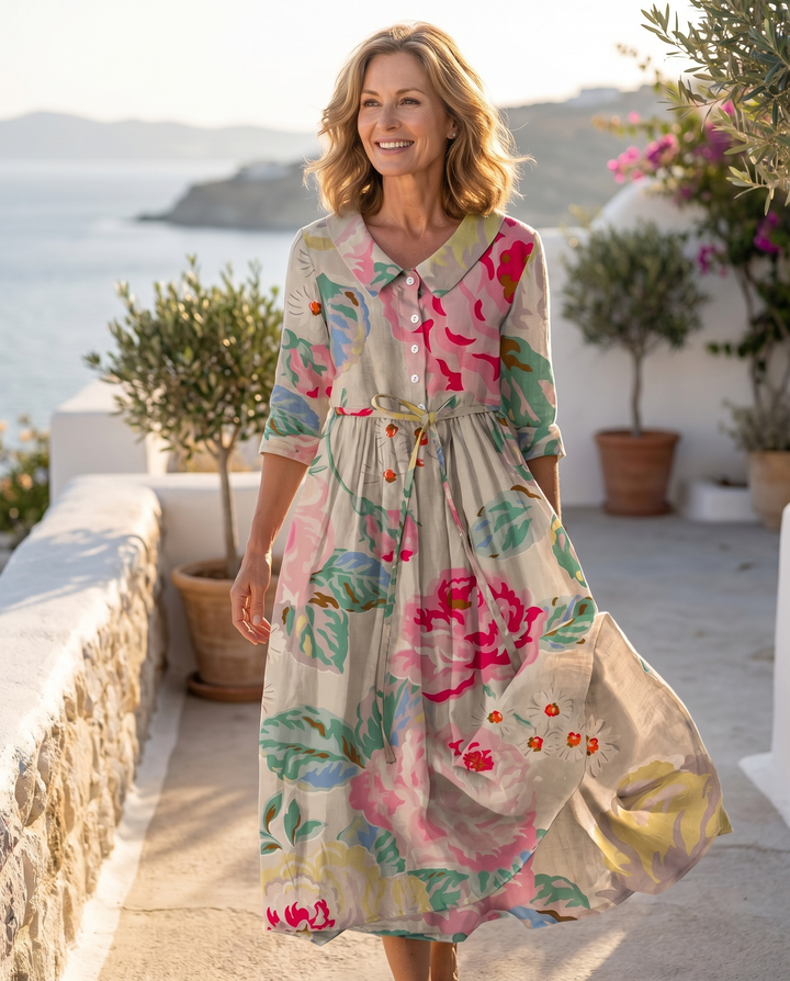 Model wearing the Myzareah dress on a sunlit coastal terrace