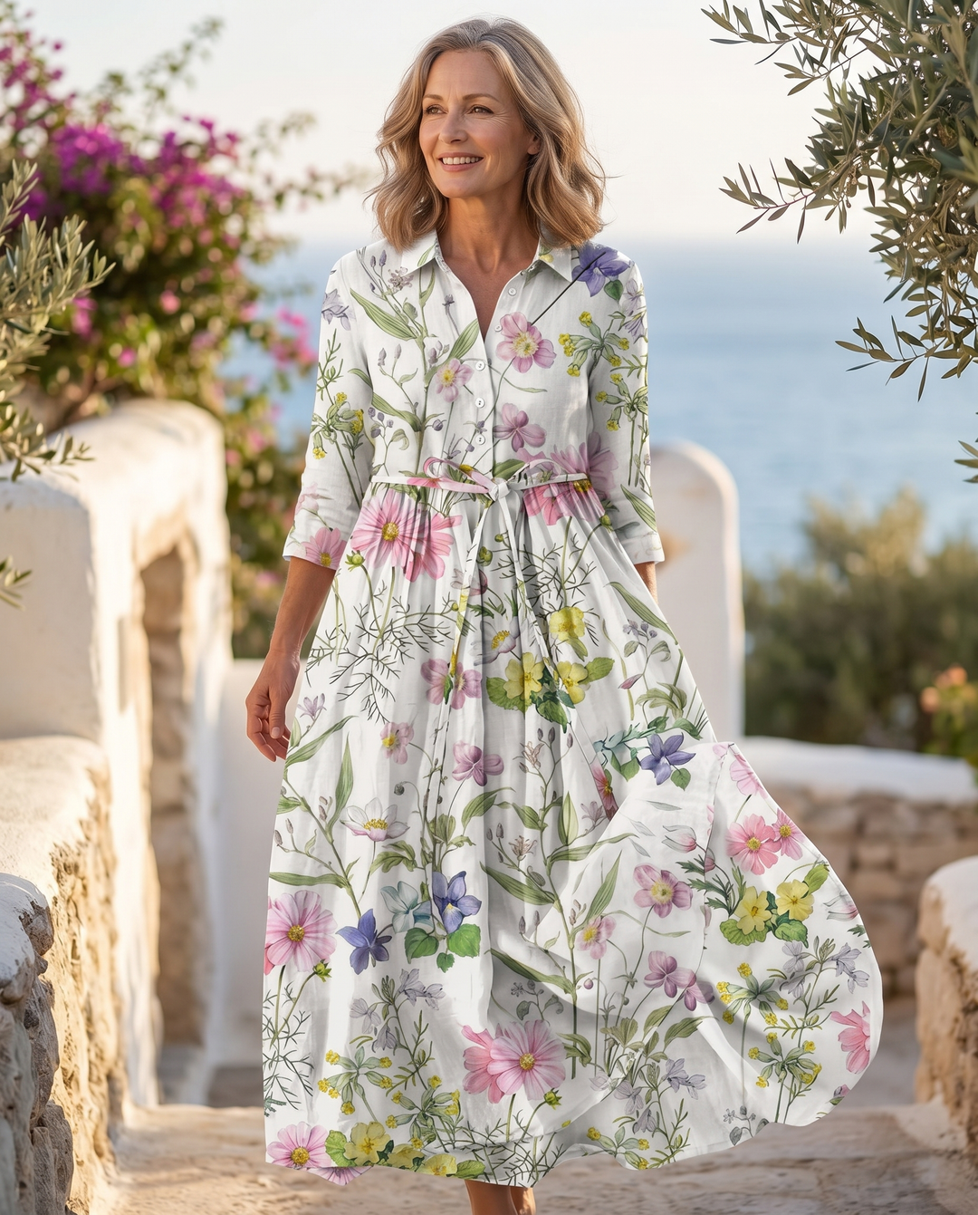 Model wearing the Eryzelle dress on a sunlit coastal terrace