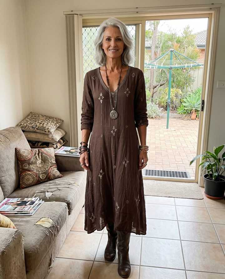 Woman at home wearing the Bea long-sleeve vintage midi dress